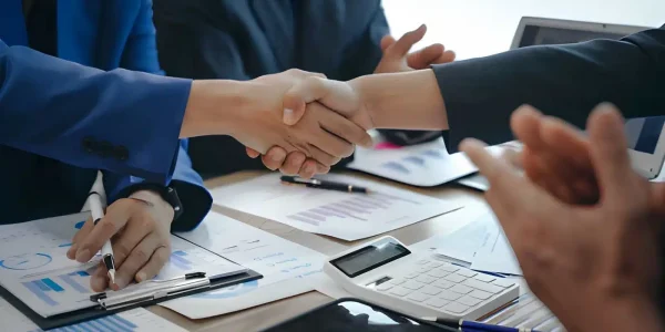 community association management consulting program Board member and community association manager shaking hands over association financial reports